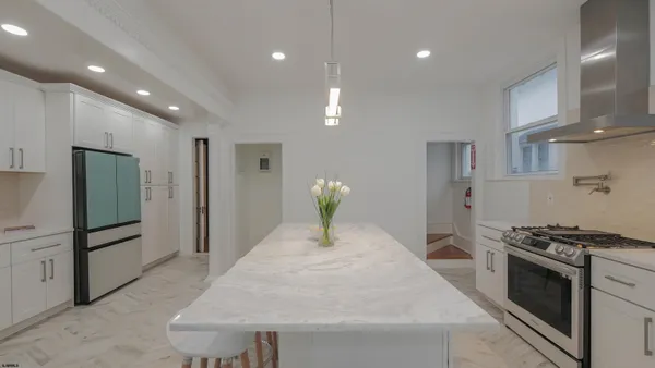 a living room with furniture a fireplace and a large window