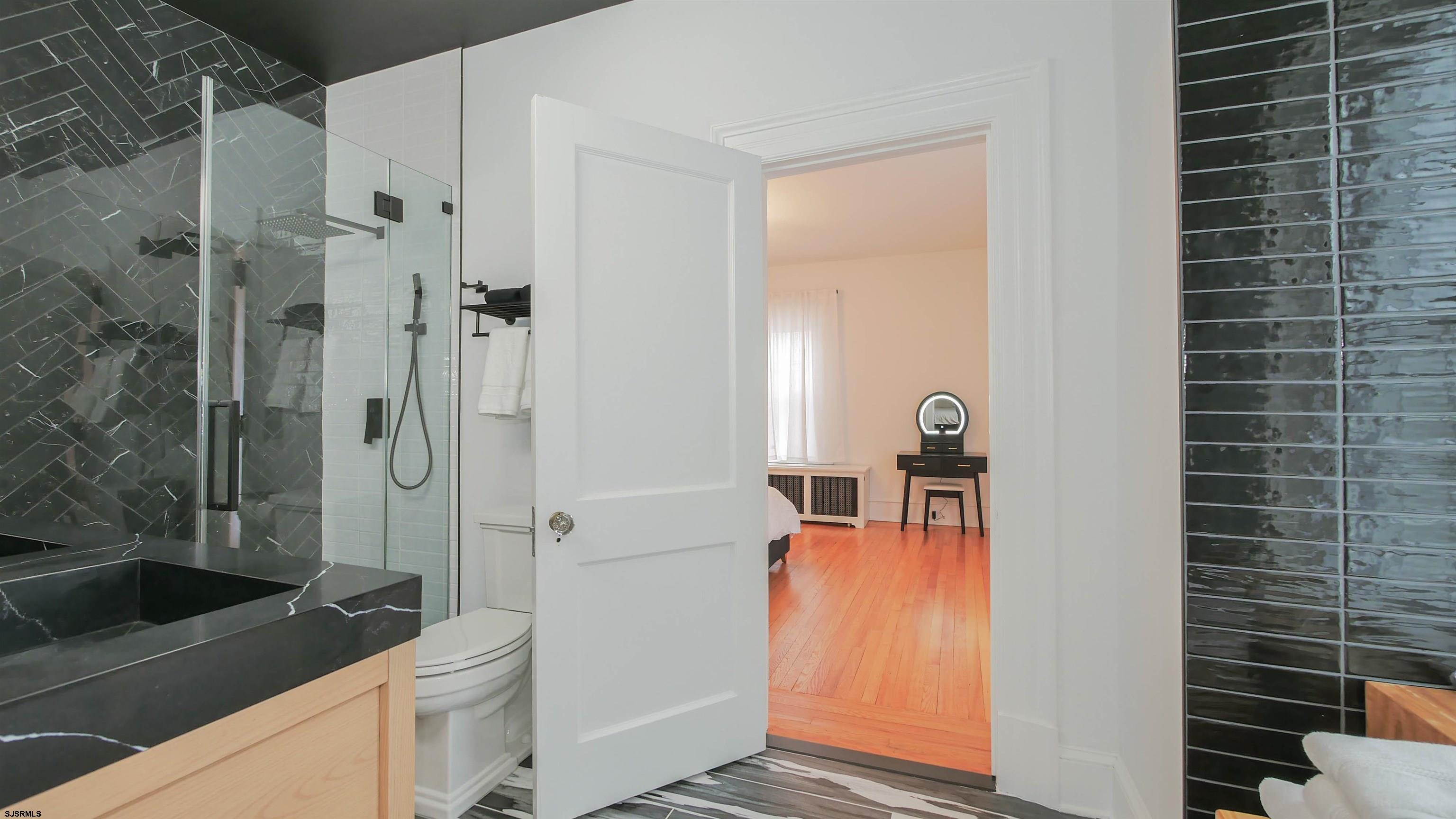 4700 Atlantic Avenue Atlantic City, NJ 08401 - Photo 38 of 74 a bathroom with a sink a toilet and shower