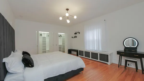 a bedroom with a bed and a table in it