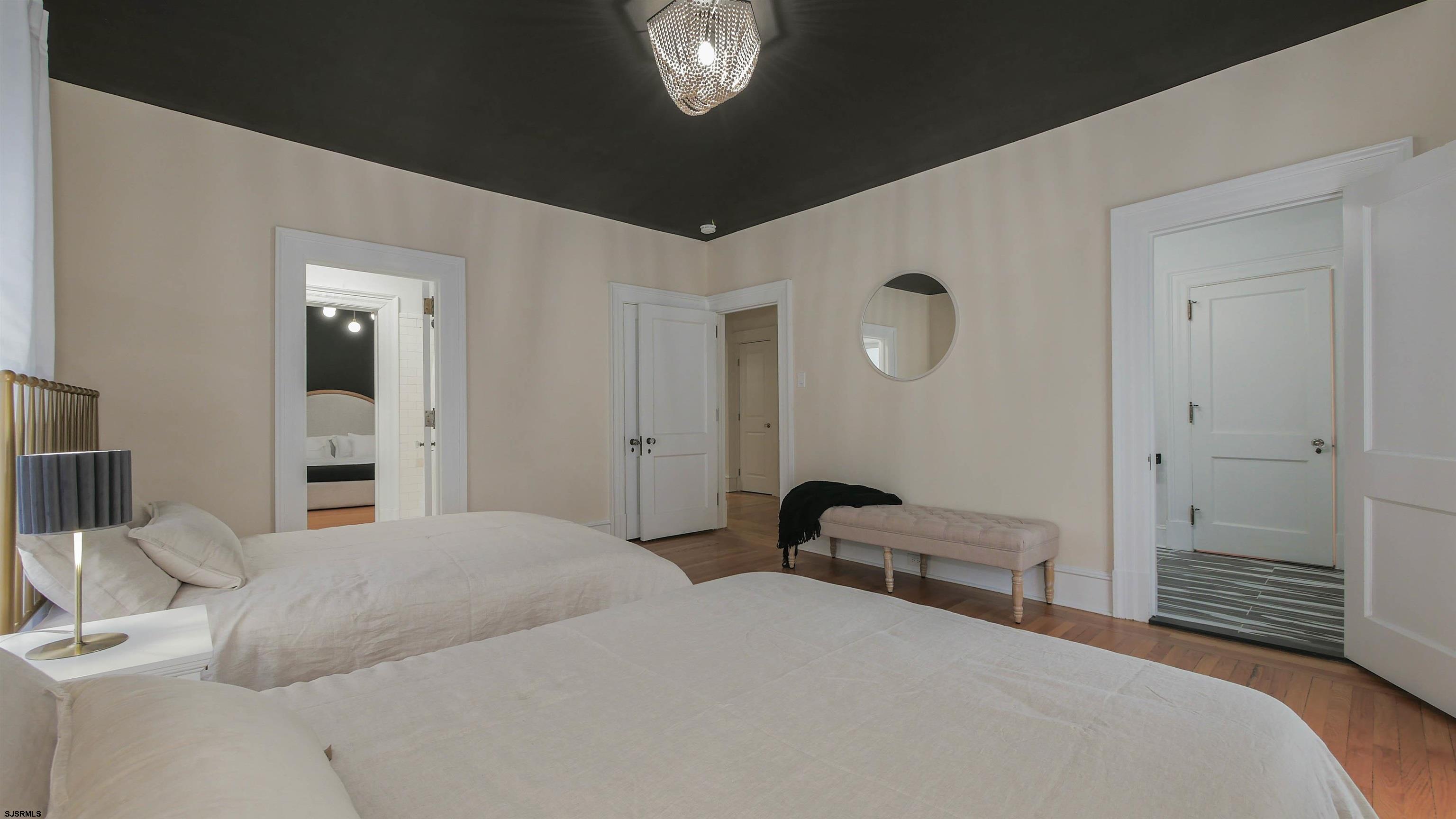 4700 Atlantic Avenue Atlantic City, NJ 08401 - Photo 42 of 74 a bedroom with a bed and a chandelier