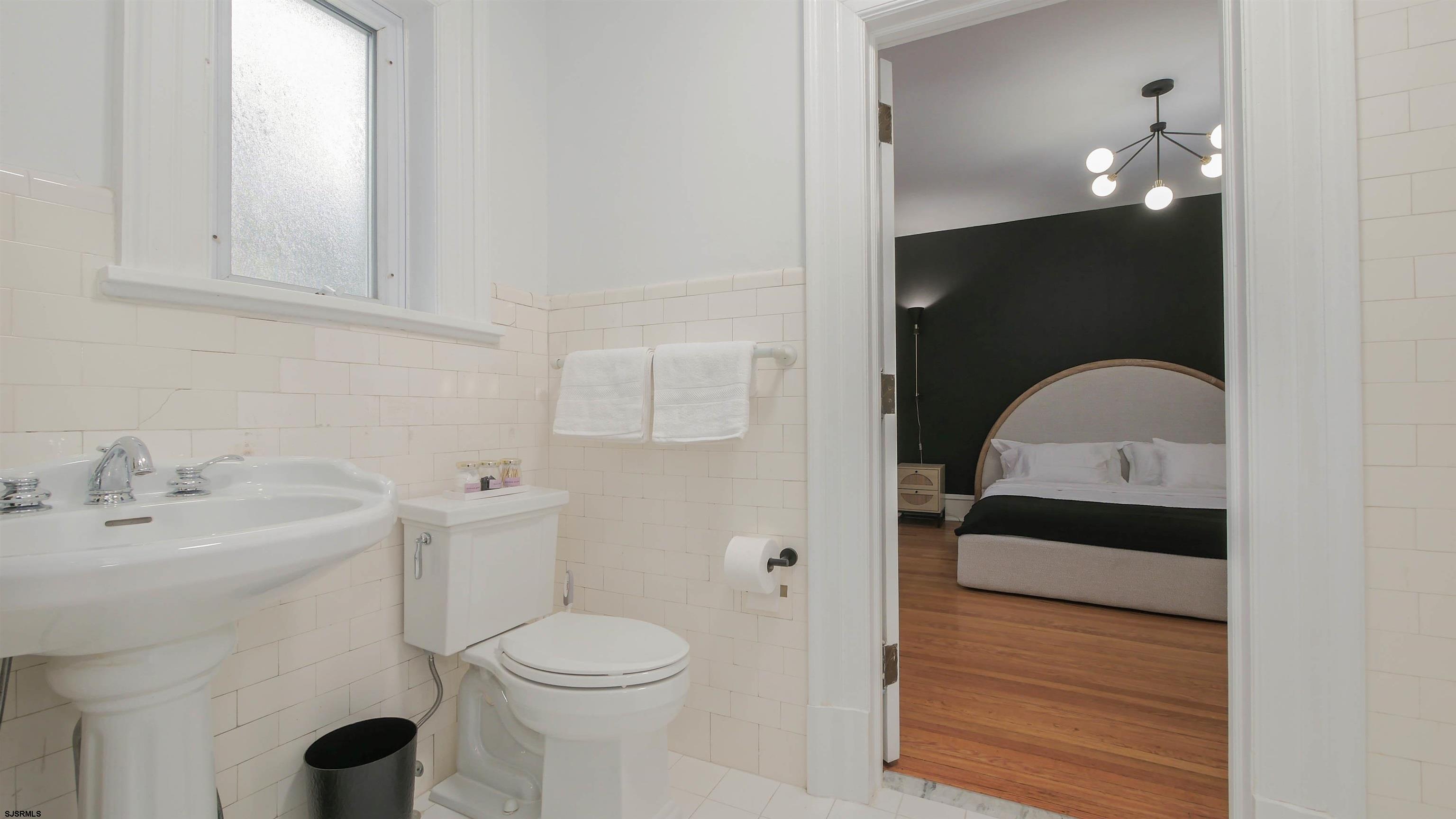 4700 Atlantic Avenue Atlantic City, NJ 08401 - Photo 43 of 74 a bathroom with a sink toilet and vanity