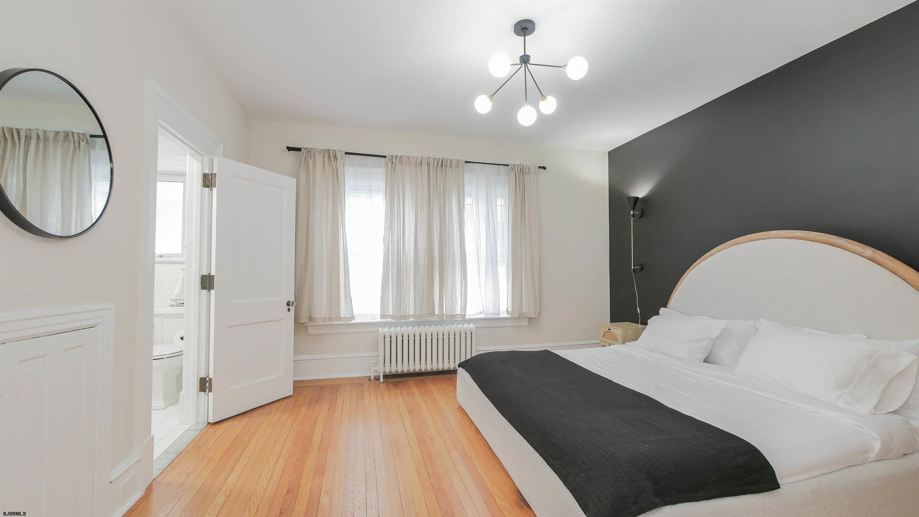 4700 Atlantic Avenue Atlantic City, NJ 08401 - Photo 47 of 74 a bedroom with a bed and a mirror