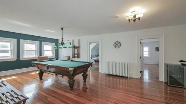 a spacious bedroom with two beds and wooden floor