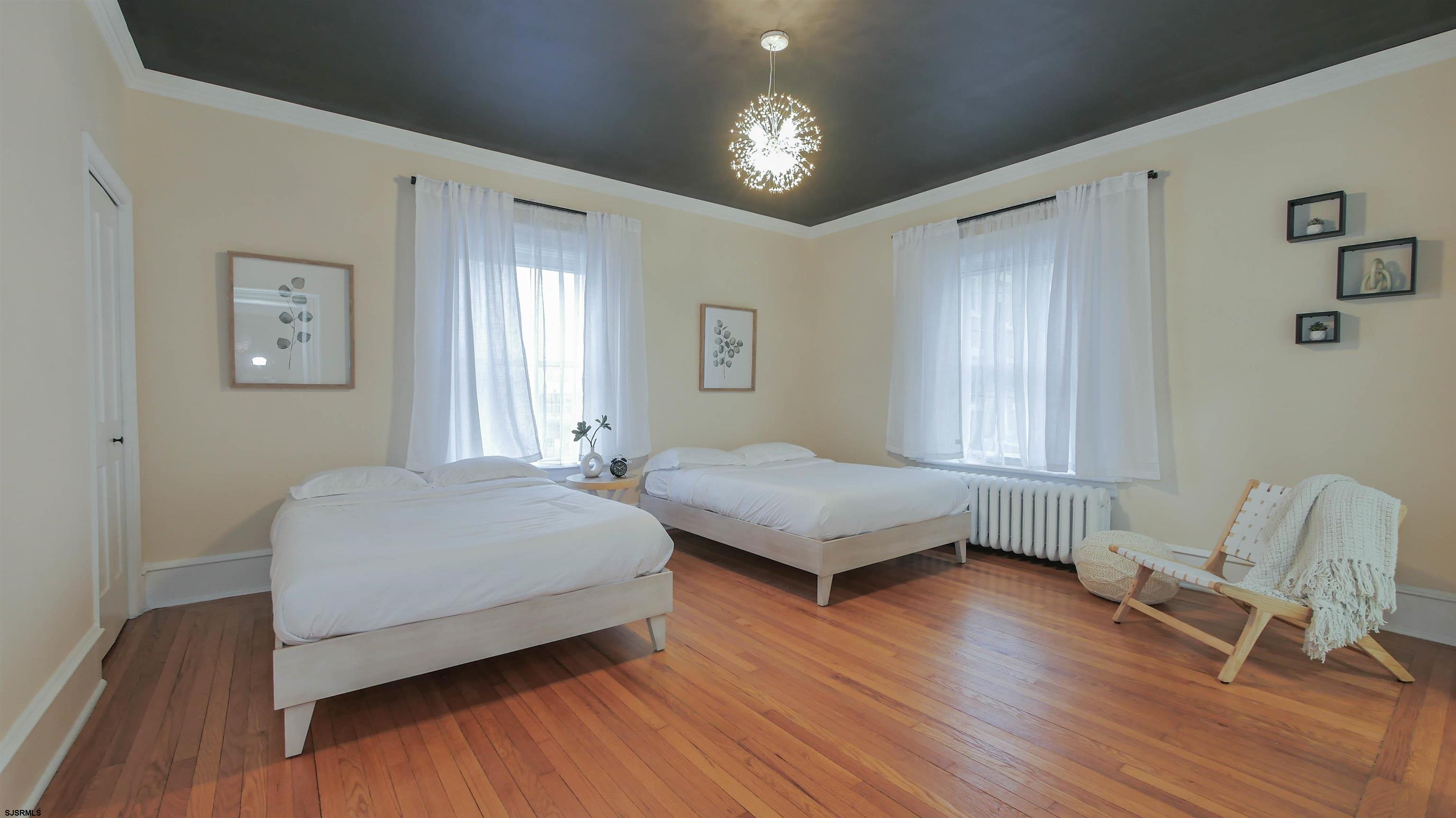 4700 Atlantic Avenue Atlantic City, NJ 08401 - Photo 49 of 74 a bedroom with a bed and a chair