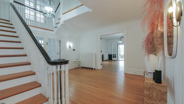 a view of entryway with wooden floor and stairs