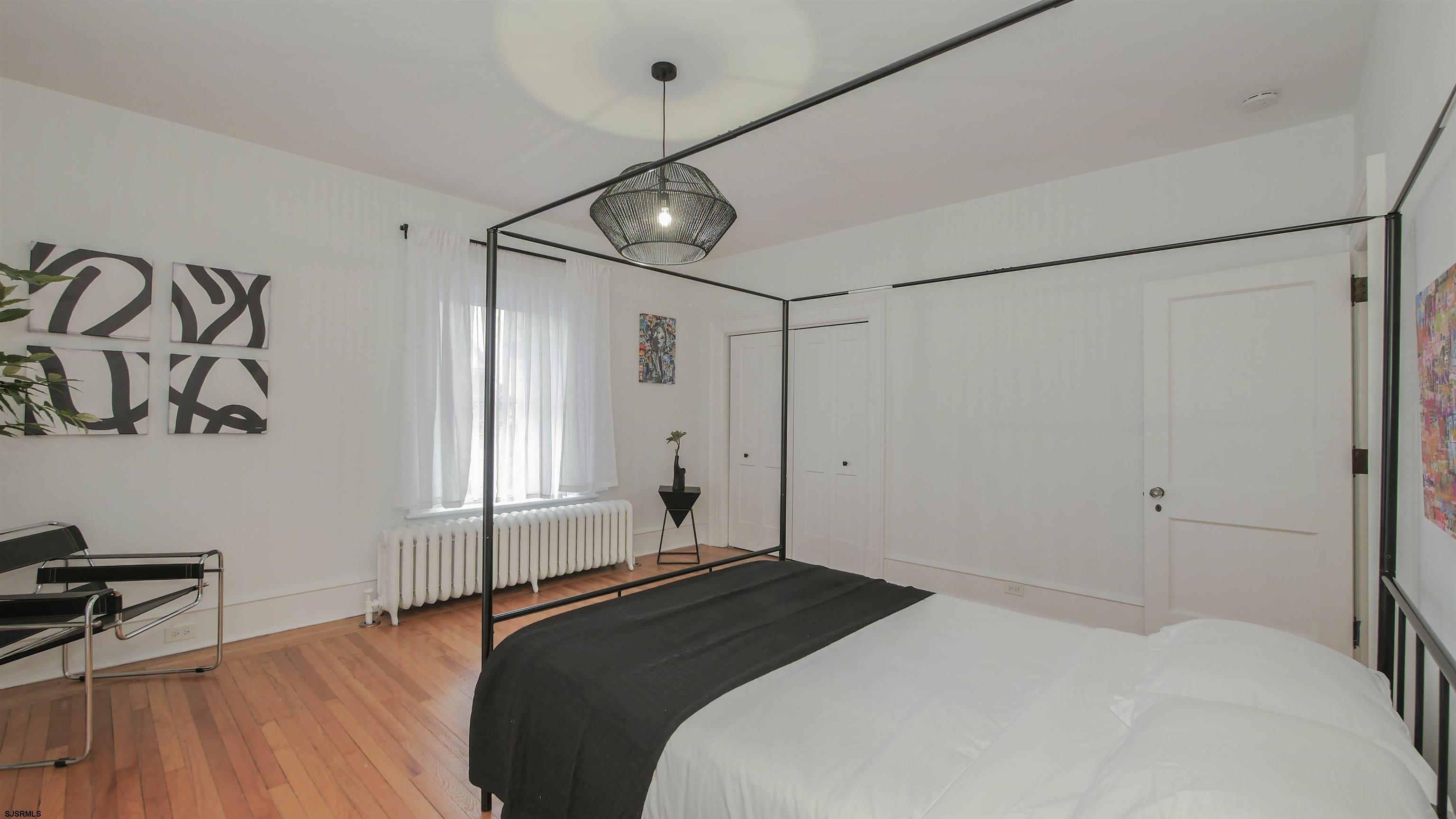 4700 Atlantic Avenue Atlantic City, NJ 08401 - Photo 53 of 74 a bedroom with a bed and a table in it