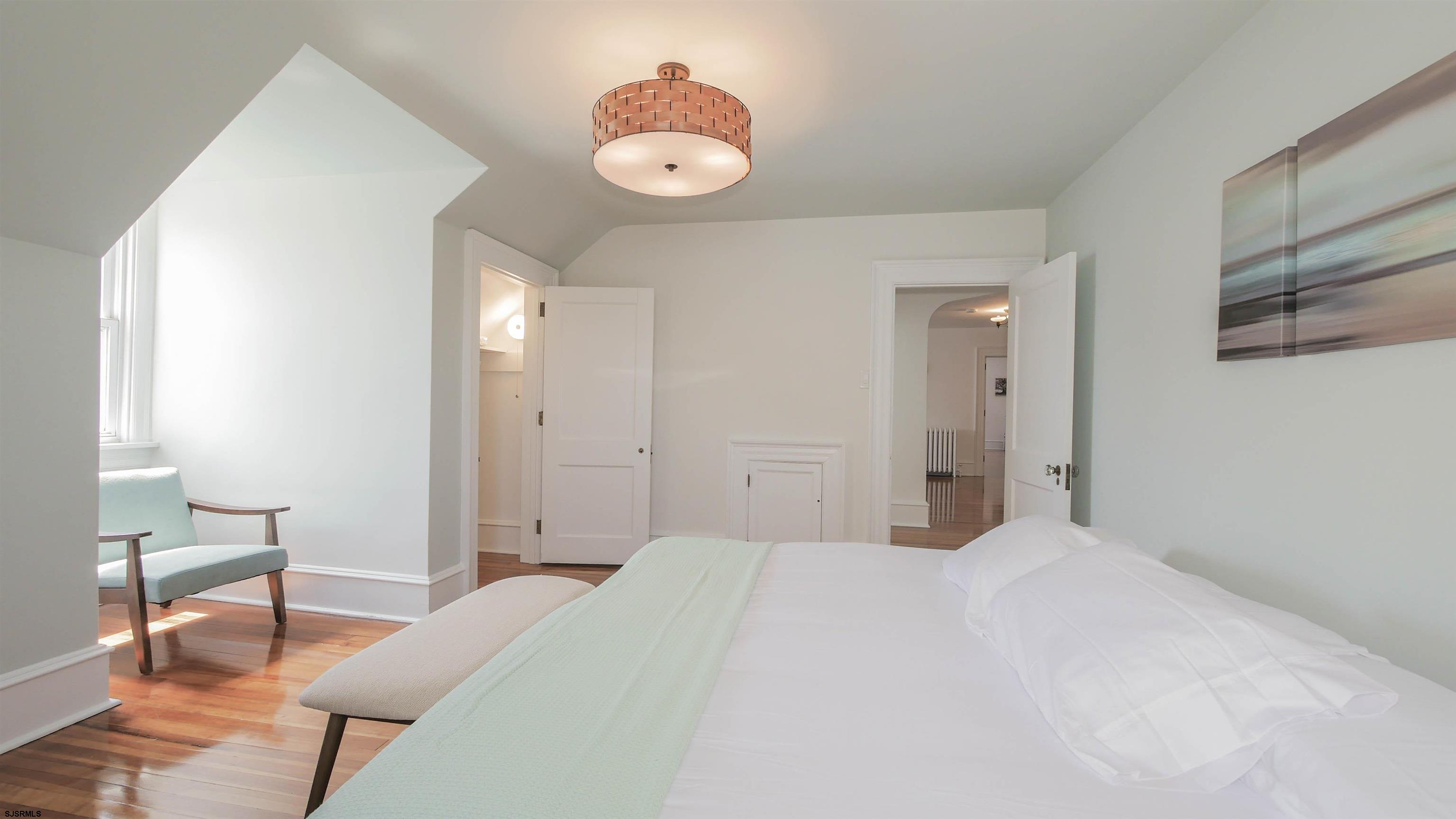 4700 Atlantic Avenue Atlantic City, NJ 08401 - Photo 60 of 74 a bedroom with a bed and a chair