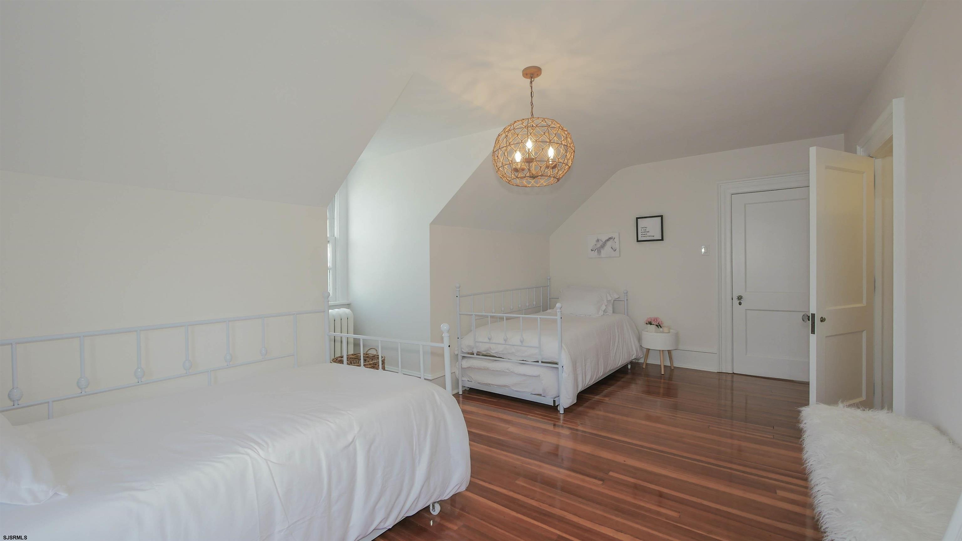 4700 Atlantic Avenue Atlantic City, NJ 08401 - Photo 69 of 74 a spacious bedroom with two beds and wooden floor