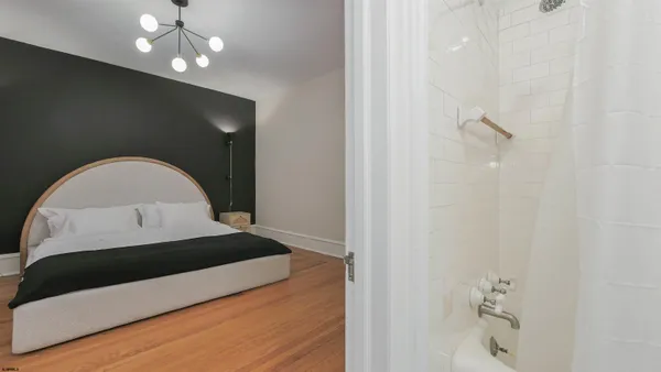 a bedroom with a bed and a chandelier