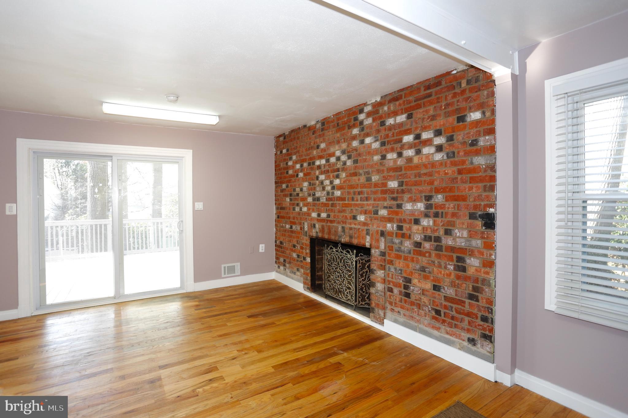 314 Summit Hall Road Gaithersburg, MD 20877 - Photo 6 of 31 Fireplace with brick mantle in living room