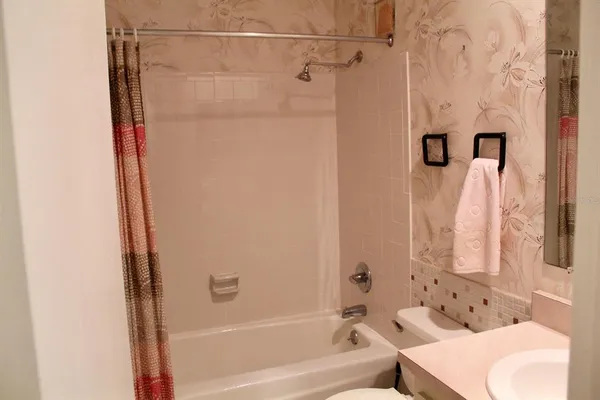 a bathroom with a shower curtain and a bathtub