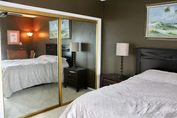 a bedroom with a bed and a painting on the wall