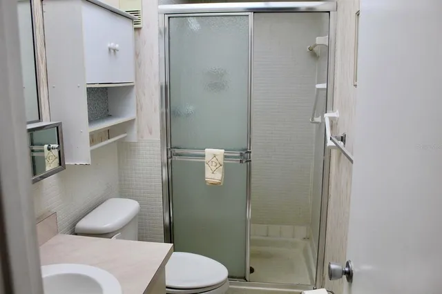 a bathroom with a toilet and a shower