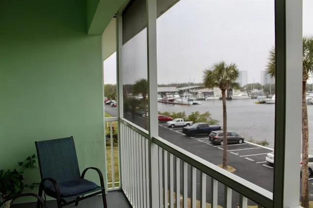 a view of a balcony with chairs and a potted plant