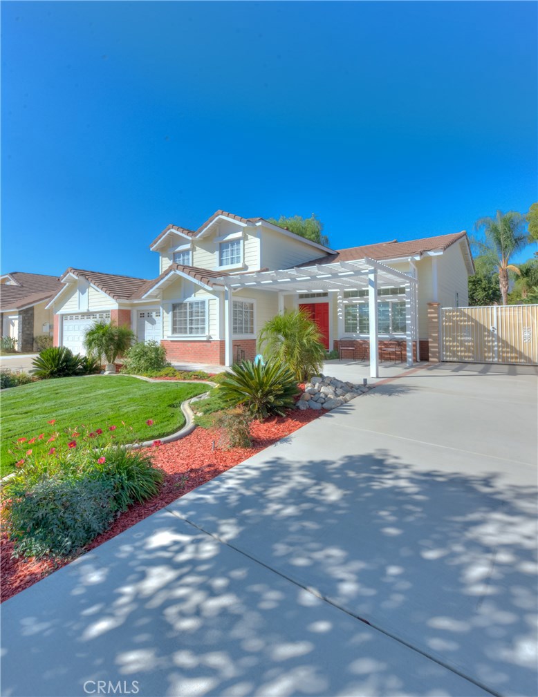 9360 Tryon Street Rancho Cucamonga, CA 91730 - Photo 1 of 1 a front view of a house with a yard and potted plants