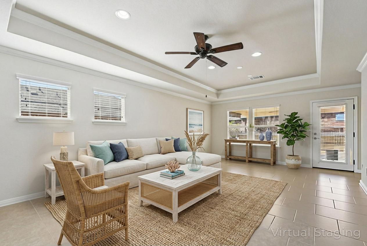 Living area with tray ceiling and abundant natural light.
(Virtually staged)