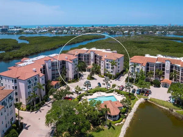 an aerial view of residential houses with outdoor space and seating