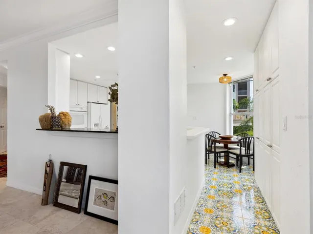 a bedroom with a bed a chair and next to a window