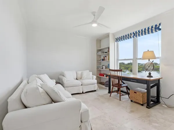 a living room with furniture and white walls