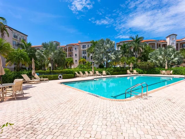 a front view of a house with garden and trees