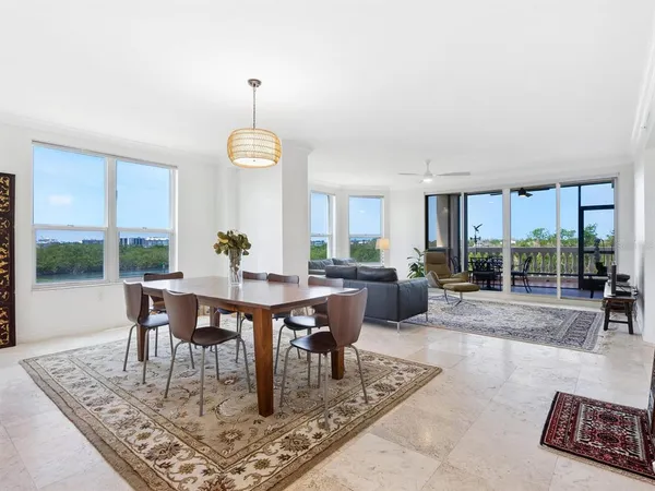 a living room with furniture and a floor to ceiling window