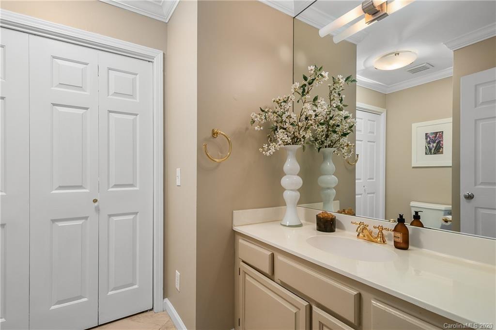 199 Chestnut Street Tryon, NC 28782 - Photo 14 of 29 a bathroom with a granite countertop sink a mirror and vanity