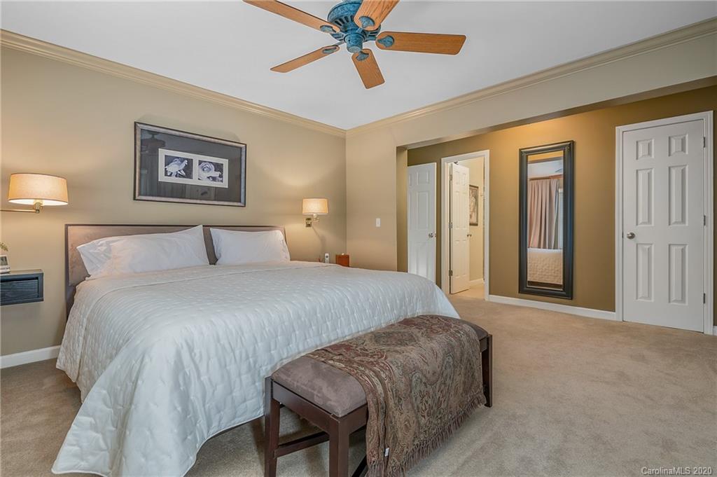 199 Chestnut Street Tryon, NC 28782 - Photo 17 of 29 a bedroom with a bed and a chandelier