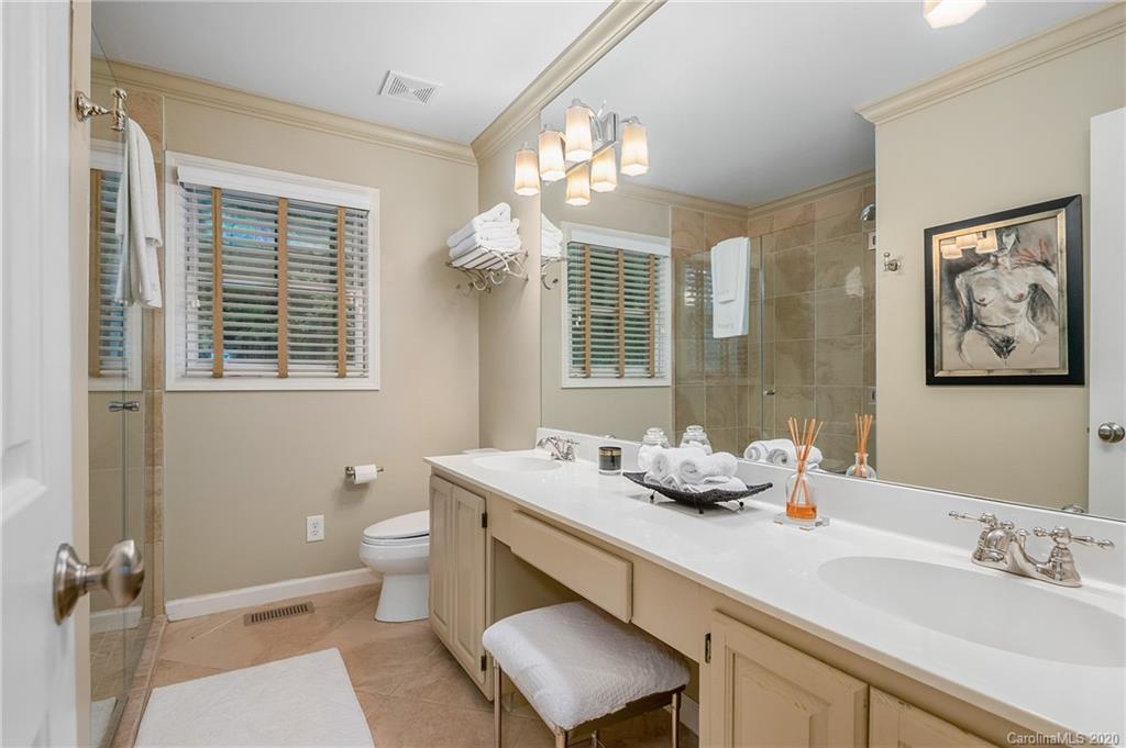 199 Chestnut Street Tryon, NC 28782 - Photo 18 of 29 a bathroom with a granite countertop sink mirror and toilet