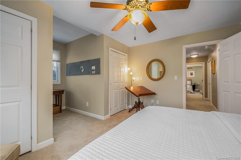 199 Chestnut Street Tryon, NC 28782 - Photo 20 of 29 a bedroom with a bed and a chandelier