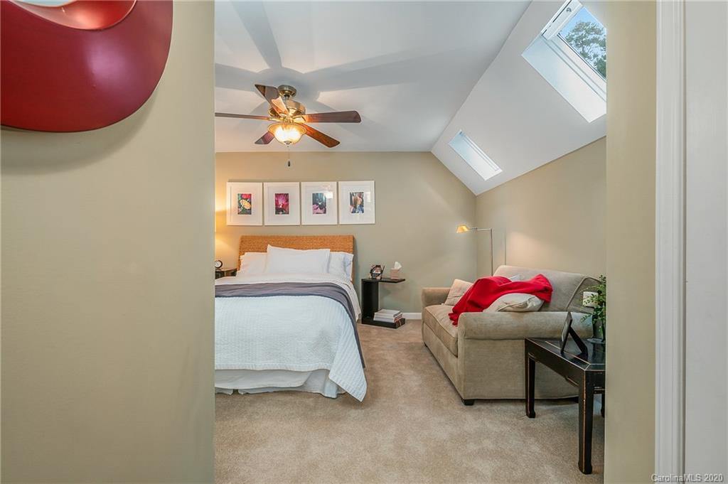 199 Chestnut Street Tryon, NC 28782 - Photo 21 of 29 a bedroom with a bed and a couch
