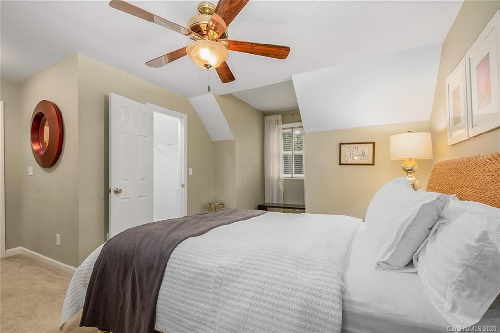 199 Chestnut Street Tryon, NC 28782 - Photo 23 of 29 a bedroom with a bed and a chandelier