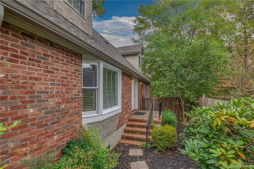 199 Chestnut Street Tryon, NC 28782 - Photo 29 of 29 a view of a pathway of a house with plants and large trees