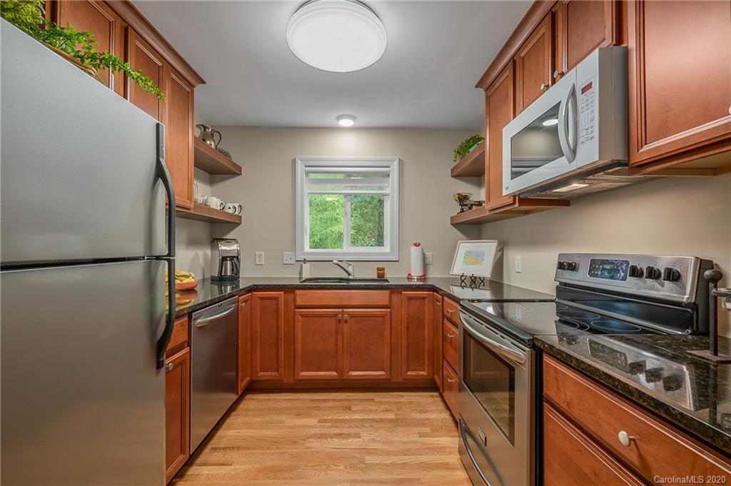199 Chestnut Street Tryon, NC 28782 - Photo 8 of 29 a kitchen with stainless steel appliances granite countertop a sink and a stove top oven
