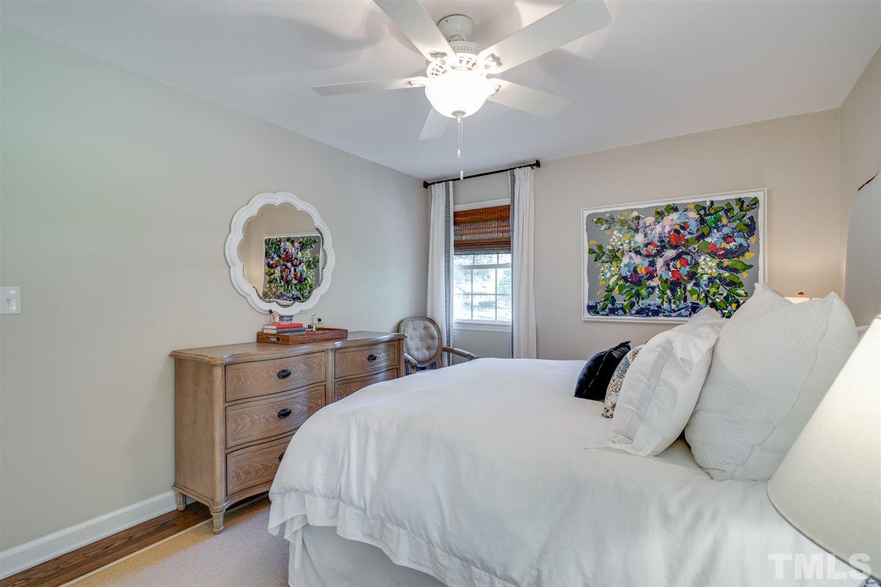 808 Davidson Street Raleigh, NC 27609 - Photo 14 of 30 a bedroom with a bed and a chandelier