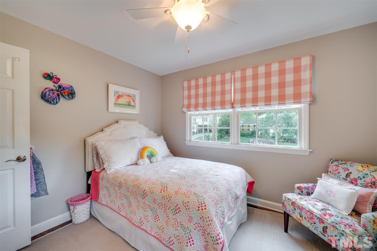 808 Davidson Street Raleigh, NC 27609 - Photo 17 of 30 a bedroom with a bed and a window