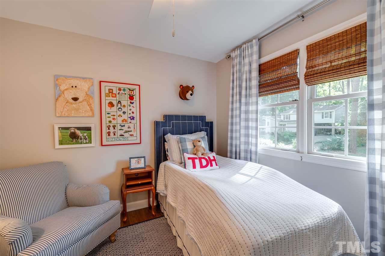 808 Davidson Street Raleigh, NC 27609 - Photo 20 of 30 a bedroom with a bed and a couch next to a window