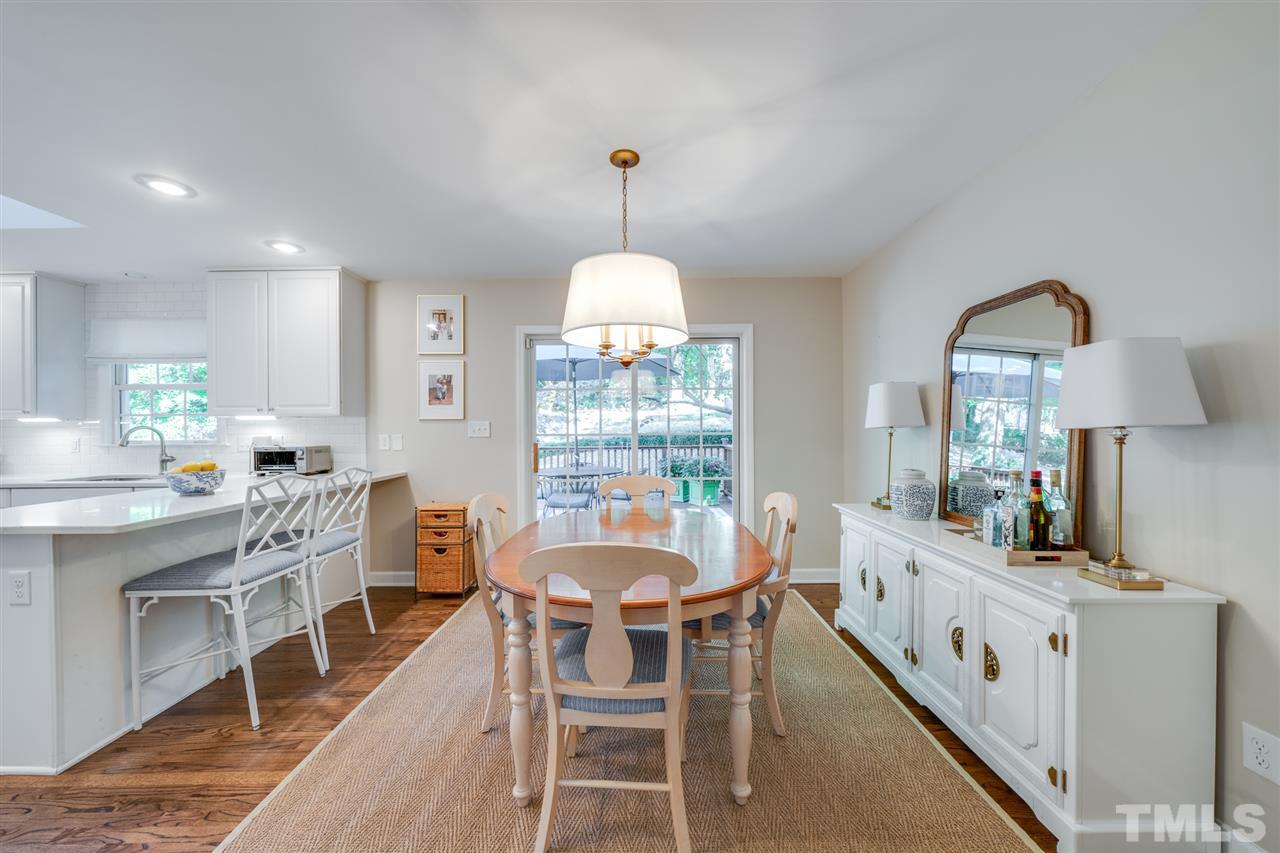 808 Davidson Street Raleigh, NC 27609 - Photo 3 of 30 a dining room with furniture a chandelier and wooden floor
