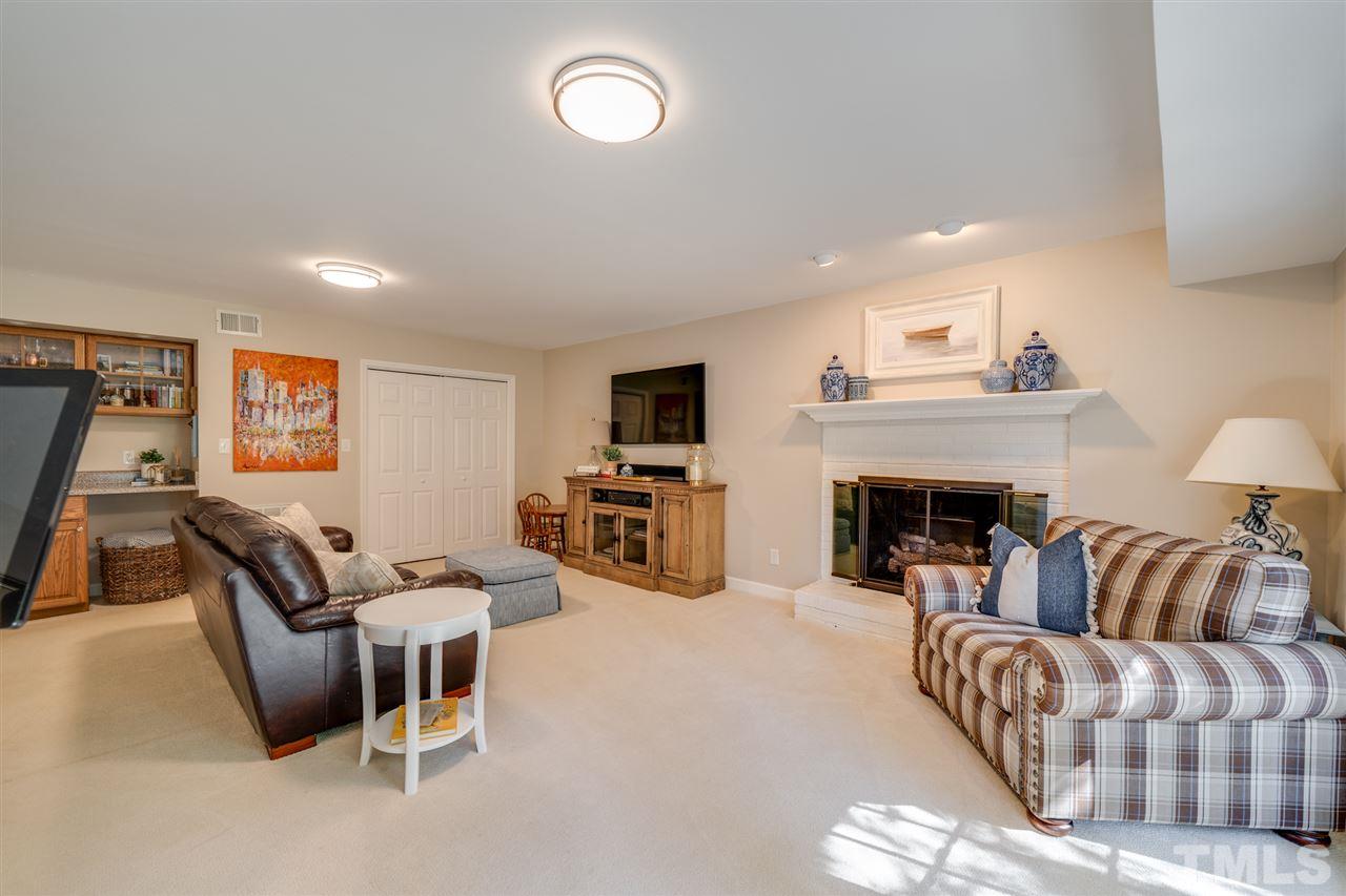 808 Davidson Street Raleigh, NC 27609 - Photo 21 of 30 a living room with furniture and a fireplace