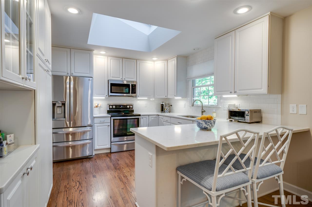 808 Davidson Street Raleigh, NC 27609 - Photo 4 of 30 a kitchen with cabinets stainless steel appliances and a counter top space