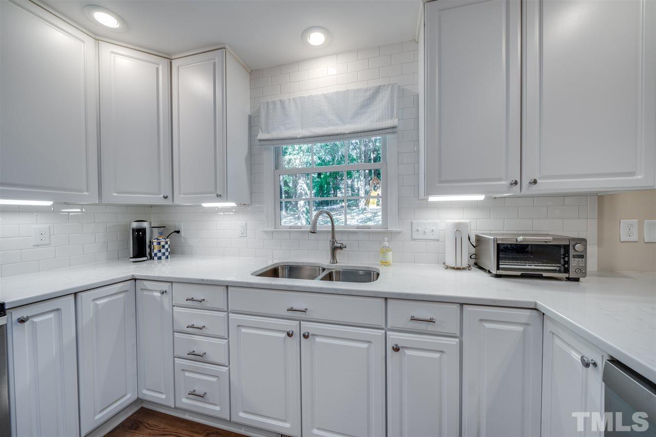 808 Davidson Street Raleigh, NC 27609 - Photo 7 of 30 a kitchen with white cabinets and a window