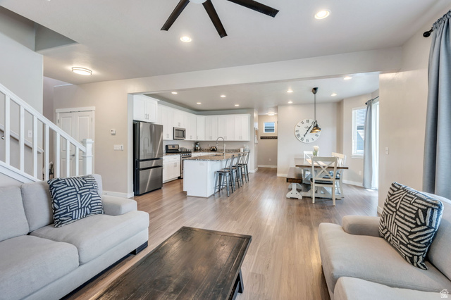 2194 Autumn Drive Mapleton, UT 84664 - Photo 12 of 41 Spacious living area with wood-finish flooring, white kitchen cabinetry, stainless steel appliances, and an eat-in dining area