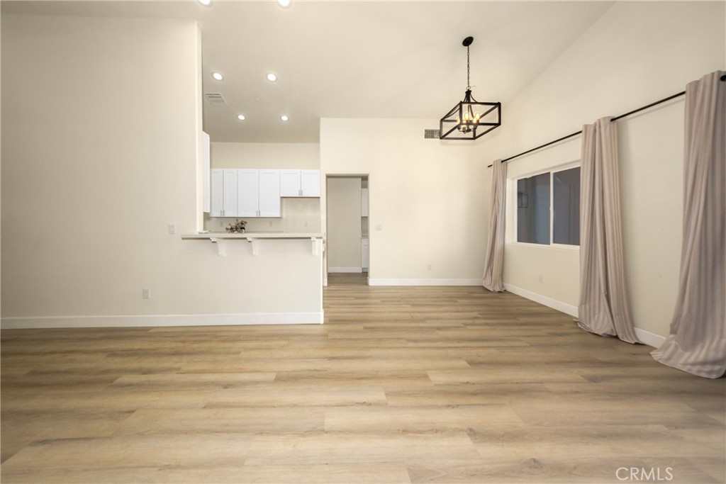 16241 Chestnut Street Hesperia, CA 92345 - Photo 13 of 60 a view of a kitchen with wooden floor and window