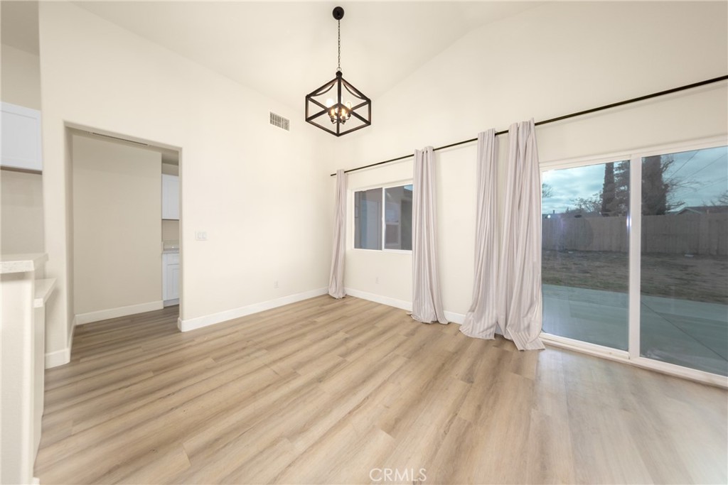 16241 Chestnut Street Hesperia, CA 92345 - Photo 14 of 60 a view of a room with wooden floor fan and windows