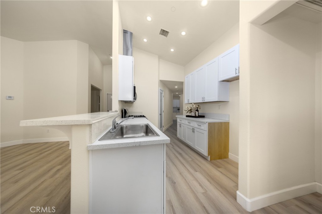 16241 Chestnut Street Hesperia, CA 92345 - Photo 16 of 60 a kitchen with a sink stove and cabinets