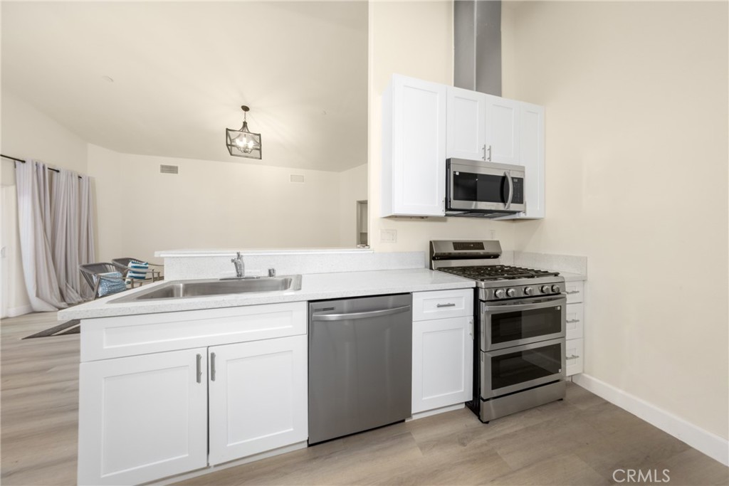 16241 Chestnut Street Hesperia, CA 92345 - Photo 18 of 60 a kitchen with appliances a sink and cabinets