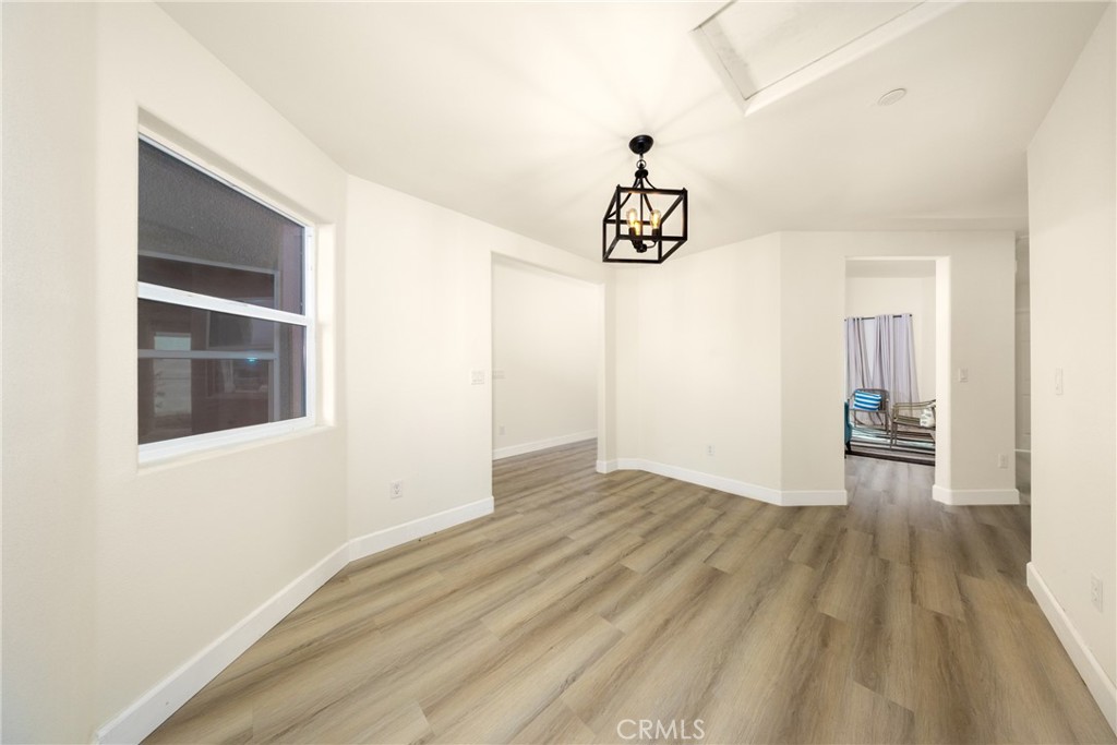 16241 Chestnut Street Hesperia, CA 92345 - Photo 32 of 60 a view of hallway with wooden floor and table