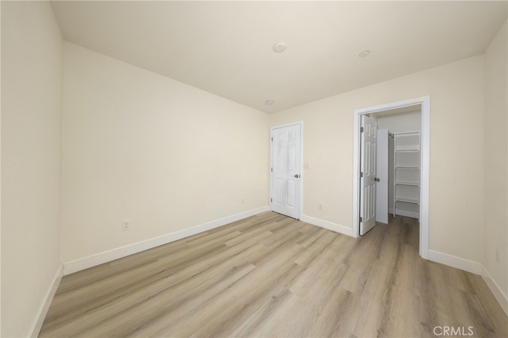 16241 Chestnut Street Hesperia, CA 92345 - Photo 35 of 60 a view of an empty room with wooden floor and closet