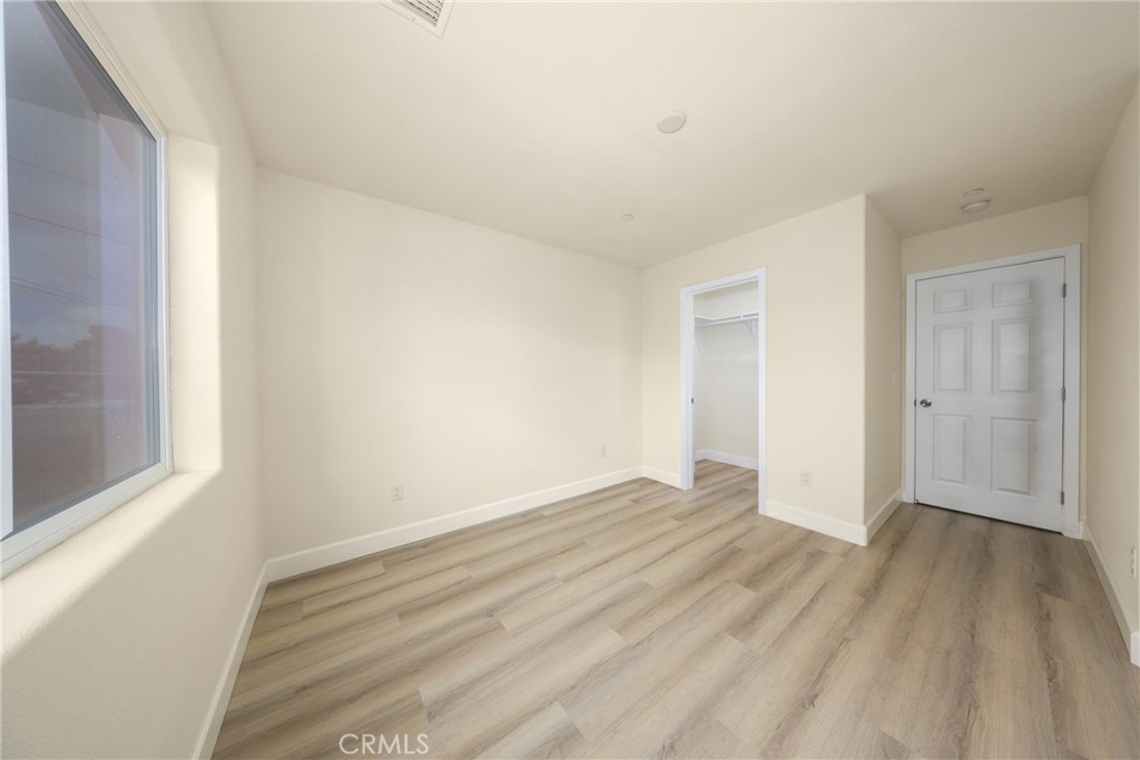 16241 Chestnut Street Hesperia, CA 92345 - Photo 38 of 60 a view of an empty room with wooden floor and a window
