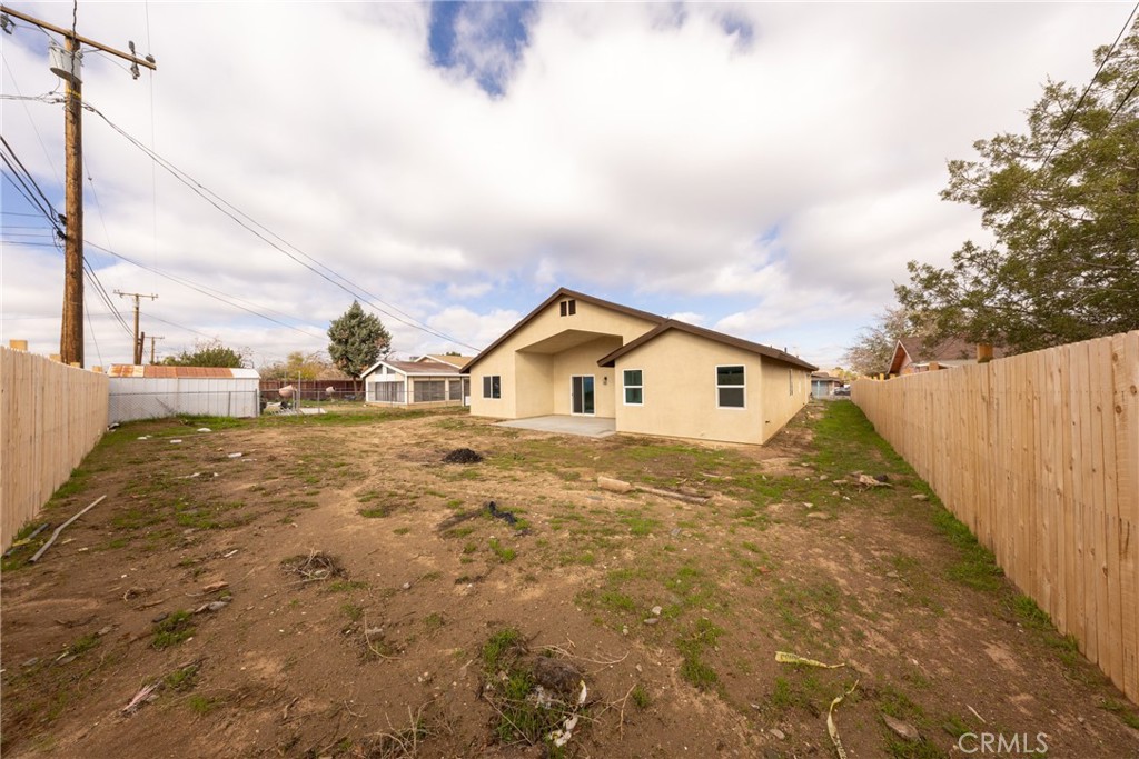 16241 Chestnut Street Hesperia, CA 92345 - Photo 41 of 60 a view of house with wooden fence next to a road