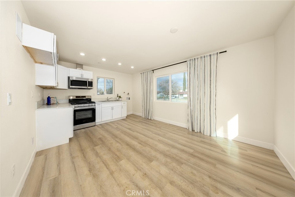 16241 Chestnut Street Hesperia, CA 92345 - Photo 43 of 60 a large kitchen with cabinets and stainless steel appliances